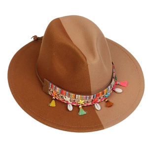 Detailed view of the woven band with shells and tassels on the gradient wool felt hat