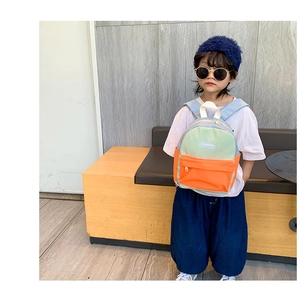 Detail of color-block kids backpack with Fashion label and adjustable shoulder straps