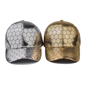 Metallic gold and silver baseball caps with black honeycomb hexagon texture on white background