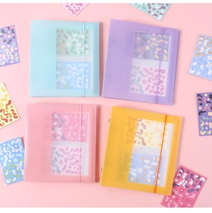 Macro shot of macaron-colored translucent binders with elastic bands and clear pocket pages