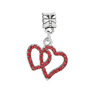 Silver alloy double interlocking heart charm with red rhinestones and bow hanger