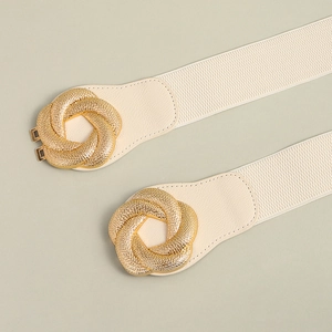 Detail of cream elastic waist belt with gold twisted geometric metal buckle design
