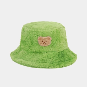 Detail of soft green faux fur bucket hat featuring a cute brown bear embroidery patch