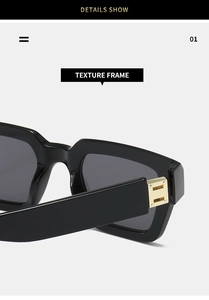 Macro shot of thick polished black square frames with premium gold metal hinge details