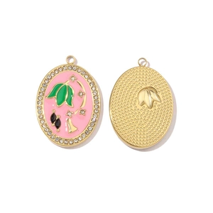 Detailed macro view of colorful enamel flower pendant with sparkling crystals and gold mesh back