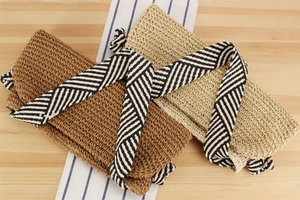 Detailed knit texture of straw shoulder bags with nautical striped knot straps