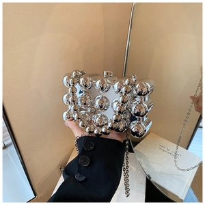 Detail of silver spherical beaded evening bag with high-gloss reflective metallic chain