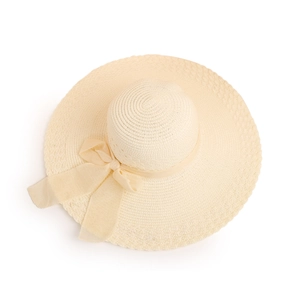 Detail of cream straw sun hat featuring woven texture and sheer mesh bow ornament