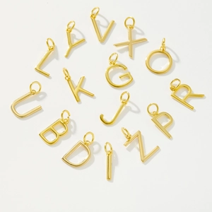 Macro shot of polished gold alphabet charms A-Z made of high-quality S925 sterling silver