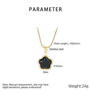 Detail of gold petal chain necklace with black glass clover pendant showing 23mm size