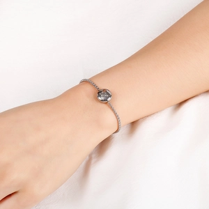 Detailed shot of Libra zodiac bracelet with sparkling stones on silver mesh chain