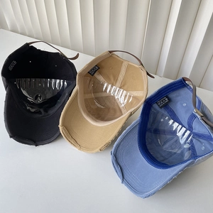 Three distressed washed cotton baseball caps with metal buckle straps in various colors