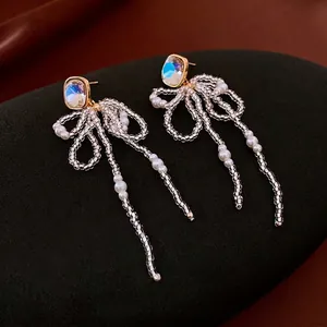 18k gold-plated long beaded bow earrings with white pearls and iridescent crystal