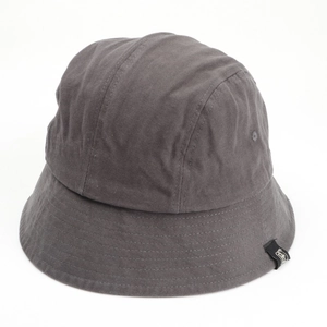 Close-up of deep gray cotton bucket hat featuring precise stitching and side woven label