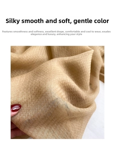 Close-up of golden silk wool blend shawl showing smooth texture and high drape fabric