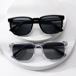 Modern square black and grey sunglasses displayed on tiered pedestals for men and women