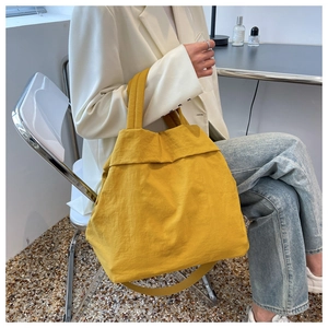Close-up of yellow lightweight nylon tote bag featuring natural texture and large capacity