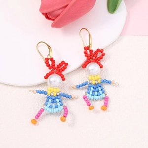 Handmade beaded cartoon character earrings with white faux pearls and colorful detail