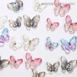 Flat lay macro of colorful resin aurora butterfly nail art and phone case ornaments