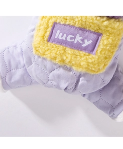 Close-up of dog winter jacket with yellow fleece and purple quilted cotton fabric