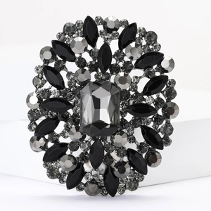 Macro detail of a vintage floral brooch with black rectangular and marquise gemstones