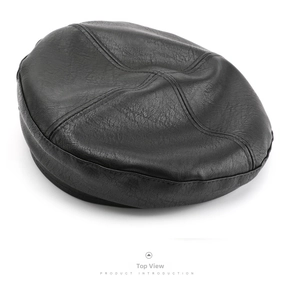 Top view detail of a black faux leather octagonal beret with cross-stitch design
