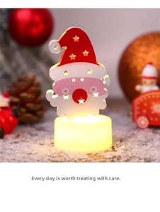 Macro detail of a wooden Santa Claus LED candle light with warm festive glowing base