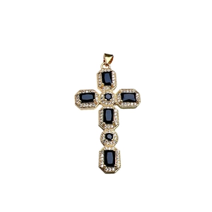 Golden cross pendant with black gems and sparkling zircon pavé setting on white background