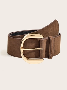 Detail of vintage brown suede wide belt with a large golden D-shaped alloy buckle