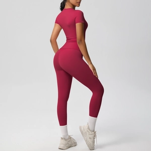 Detail view of seamless dark red yoga set showing high waist leggings and fitted short sleeve