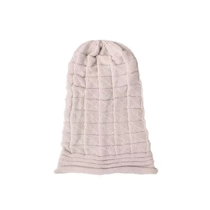 Close-up of pink beanie with waffle knit pattern showing detailed stitching texture