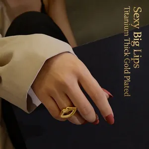 Exaggerated lip design ring in thick gold plated titanium steel worn by model
