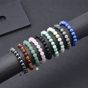 Natural stone beaded bracelets with tiger eye and lava stones on display stand
