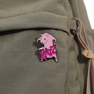 Close-up of a pink enamel RATZ cartoon mouse brooch pinned on an olive green canvas bag