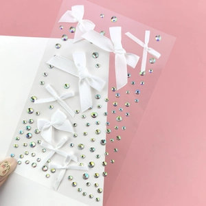 Detail of white ribbon bow and iridescent rhinestones for fairy eye makeup looks