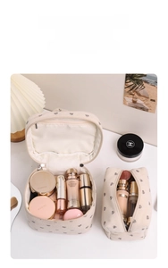 Detailed view of cream corduroy heart-print makeup bags showing large storage capacity