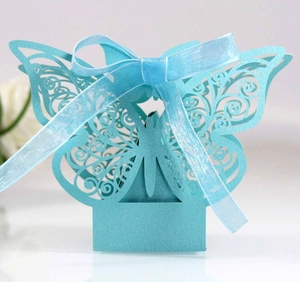 Detail showing blue laser-cut butterfly candy box with pearlescent finish and ribbon bow