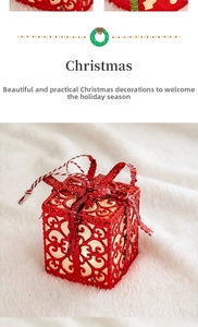 Glowing red Christmas gift box ornament, delicate hollow design for festive home decor.