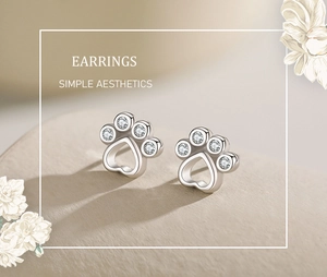 Close-up of S925 sterling silver bear paw earrings with sparkling crystal pavé stones