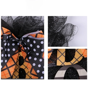Detail of Halloween wreath featuring mesh fabric, ribbons and BOO signage ornaments