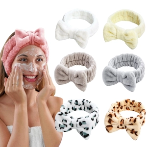 Detail of coral fleece headband set in pink, white, and leopard print soft textures