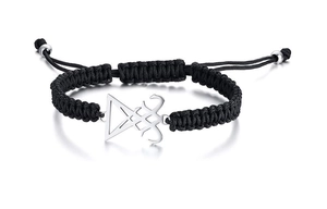Detailed close-up of woven black rope bracelet with stainless steel Leviathan cross charm
