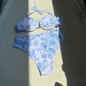 Floral bikini set with halter top and high-waisted bottom featuring vintage blue flower print