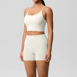 Macro shot of seamless high waist yoga shorts and U-neck sports bra in cream white
