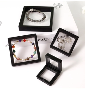 Detail showing square black PE film jewelry display boxes with floating necklaces