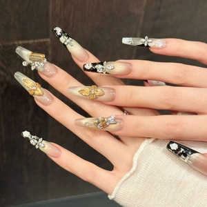 Detailed view of luxury hand-painted floral press-on nails with zircon and gold charms