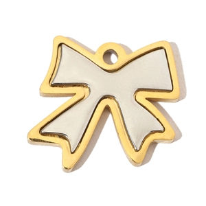 Detailed macro view of a two-tone bow-shaped stainless steel pendant with gold and silver finish