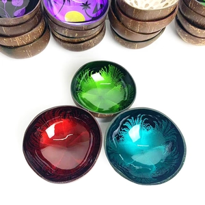 Detailed view of colorful hand-painted coconut shell bowls with feather patterns