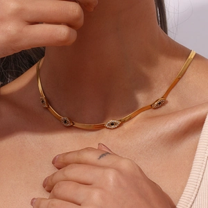 Close-up of gold 18K plated evil eye necklace with crystals on flat snake chain