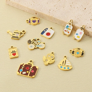 Detailed view of 10 gold enamel charms including camera and suitcase for DIY jewelry